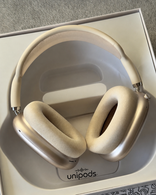 Beige over-ear wireless headphones named airpods max copy clone resting inside their white retail box, with the Unipods logo visible on the insert.